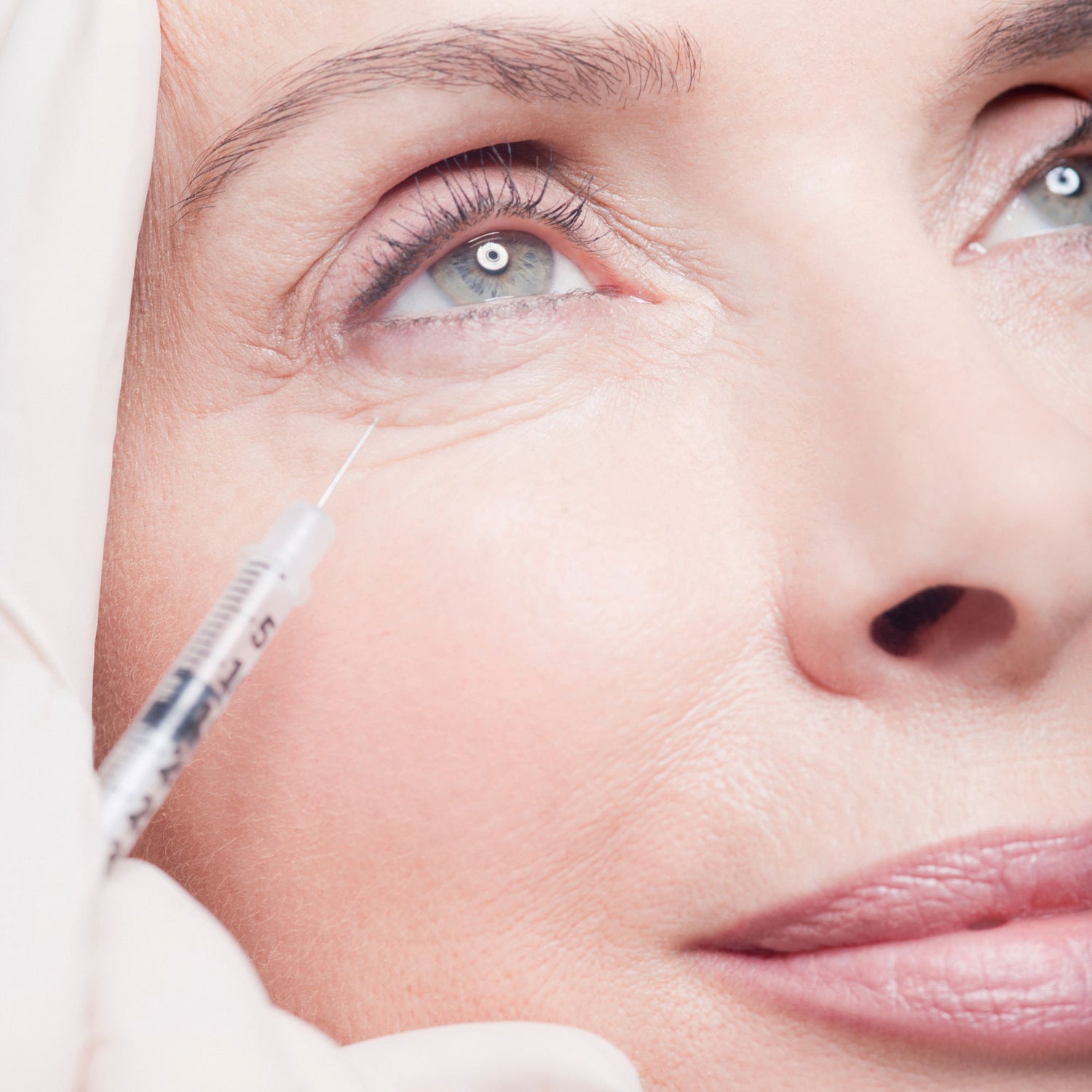 beautiful older woman getting botox around her eye