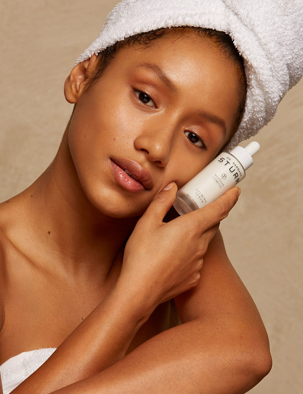 girl holding Dr. Sturm Calming Serum against her face