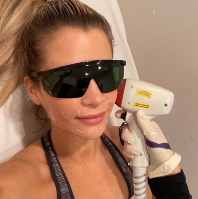 client at ella ora skin therapy clinic with laser glasses on