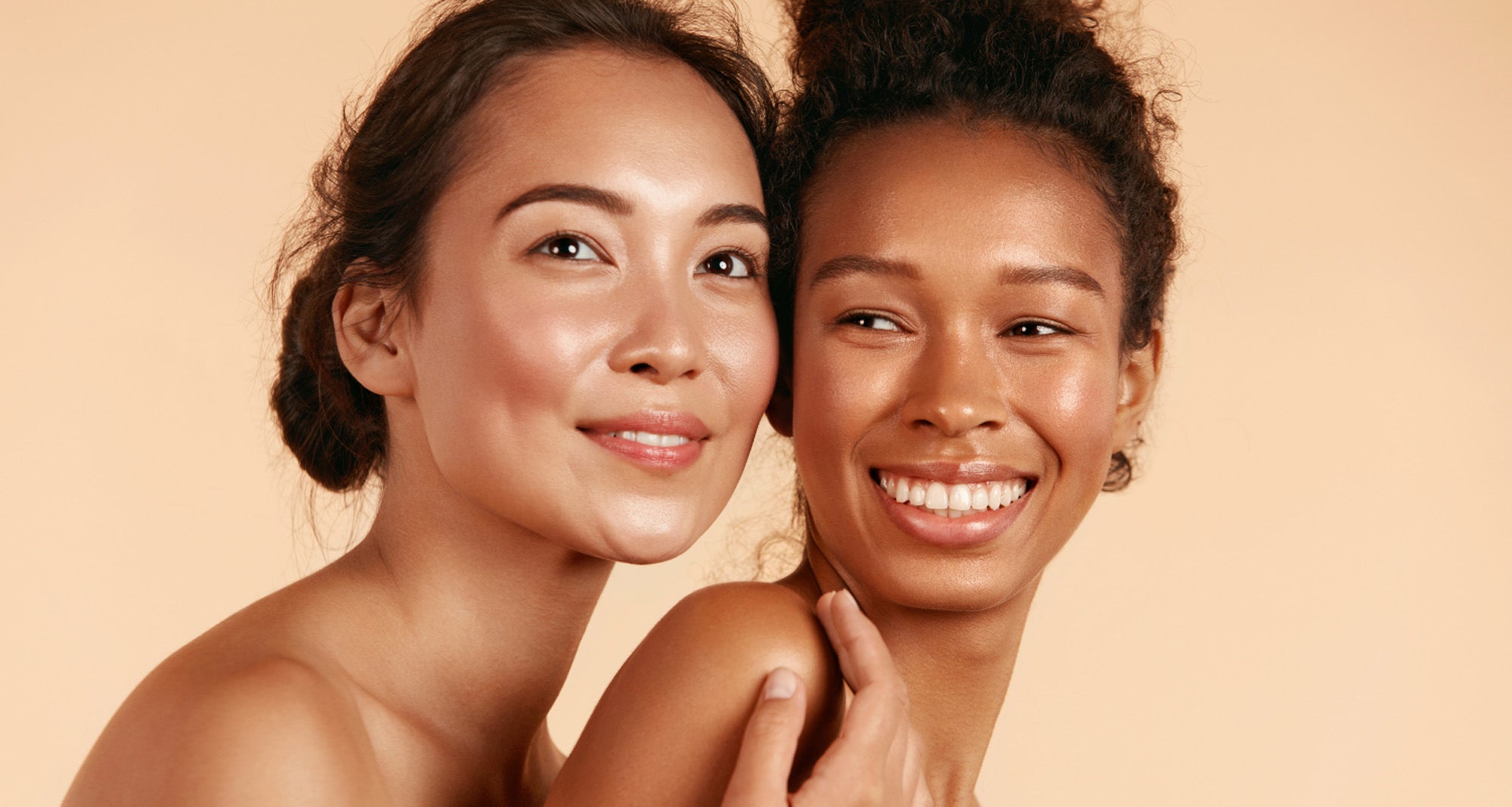 2 younger girls with beautiful skin smiling