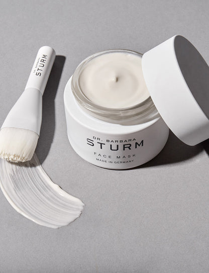 Barbara Sturm Hydrating Face Mask with lid off and a brush to wipe on face