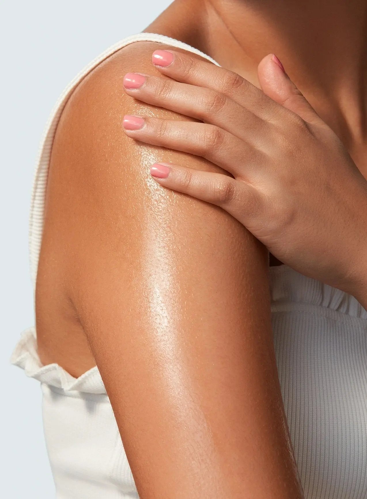 Supergoop Glow Oil SPF 50 rubbed on skin of woman