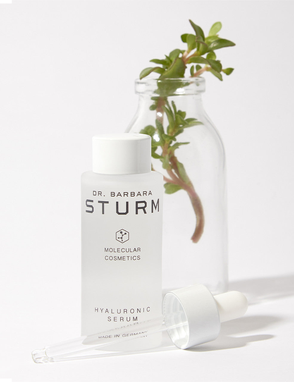 Dr. Sturm Hyaluronic Serum beside a plant in a jar