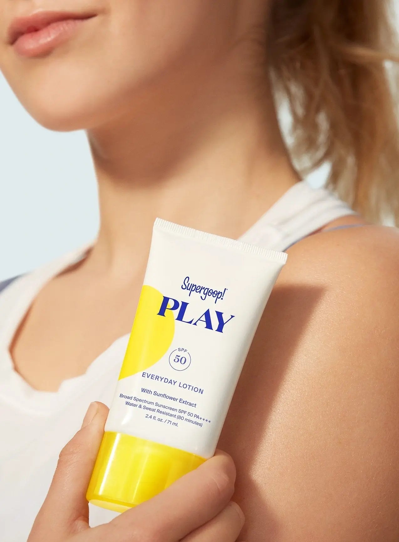 girl holding up Supergoop Play SPF 50